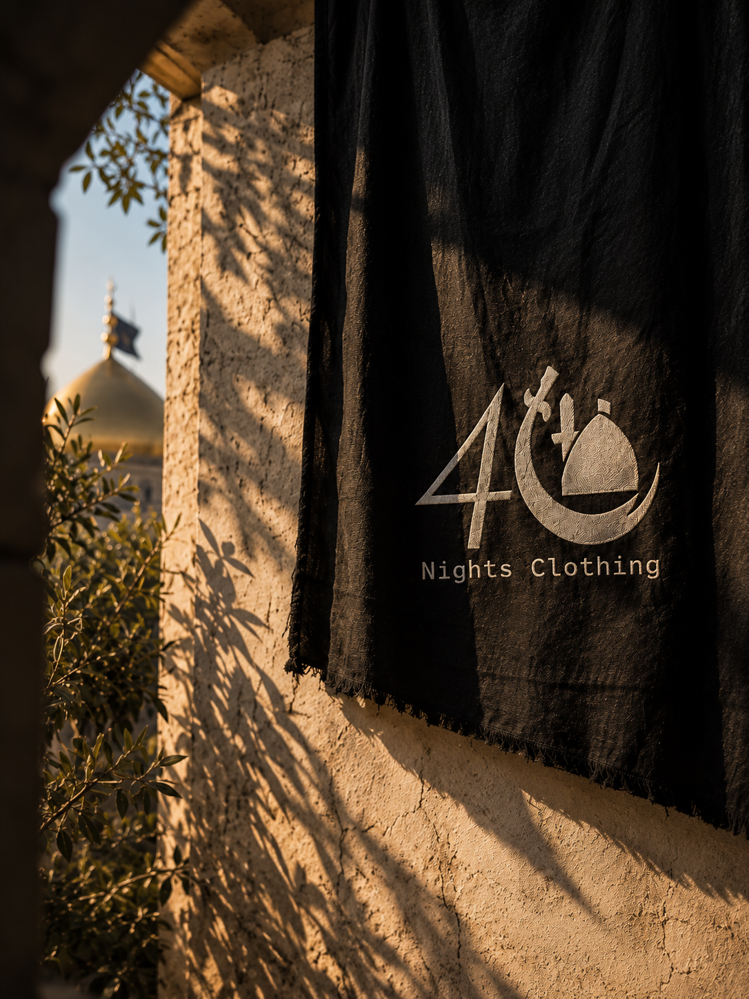 Authentic black 40 Nights Clothing flag carrying the original logo beside sunlit stone architecture